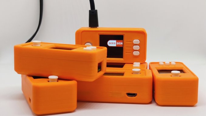 A batch of orange SeedSigner devices, with one displaying the "SEEDSIGNER" logo on its screen, are arranged together along with their accompanying components, ready for shipping to customers seeking secure Bitcoin self-custody solutions.