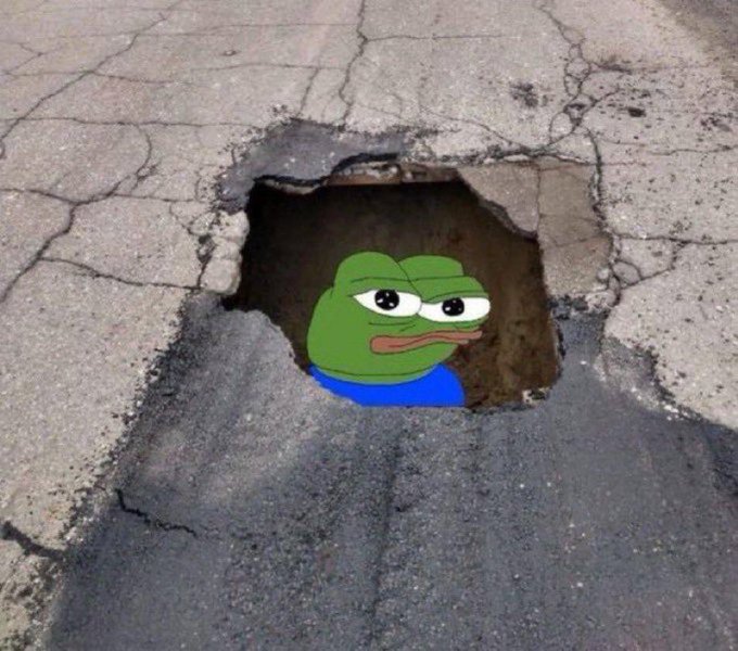 A digitally edited meme image showing a green Pepe the Frog with half-closed, smug eyes peeking out from a dark pothole in cracked asphalt.