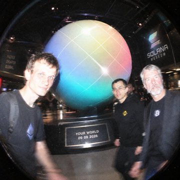 Three men posing in front of a large illuminated globe display at an expo, with a sign reading 'YOUR WORLD 09.09.2025' and 'SOLUNA SESSION' visible in the background.