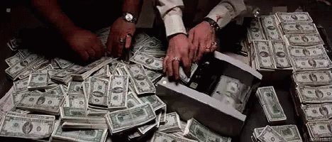 In this image, there are two men sitting at a table next to an abundance of money. A total of 55,000 tokens are spread out across the surface of the table, indicating significant financial wealth. The image also includes text that reads "My darlings, my heart," which adds a personal touch to the scene.
