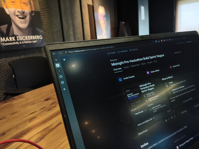 A laptop on a wooden table displaying a Luma event management page for 'Midnight Pre-Hackathon Build Sprint: Nagpur', with a Mark Zuckerberg poster visible in the background.