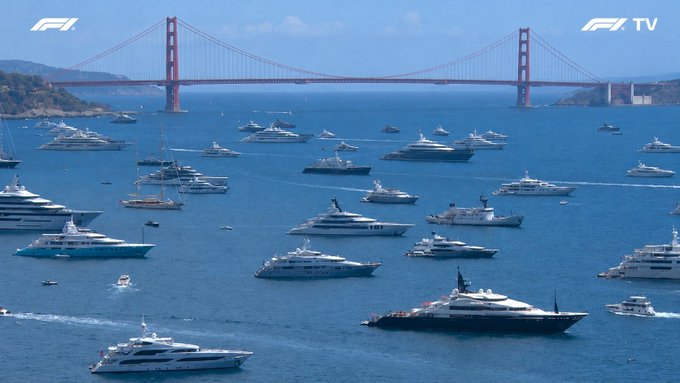 The image shows a large group of luxury yachts floating on the water, with a prominent red suspension bridge in the background. The boats are scattered across the scene, some closer to the foreground while others are further away. There are also several people visible near the boats, possibly enjoying their time on the water or attending to their vessels.

The post about Ripple Funders commuting to work in 10 years is related to this image because it highlights how these luxury yachts and the red suspension bridge could be part of a future where people commute using such high-end transportation options for their daily commutes, potentially reducing traffic congestion and promoting sustainable travel choices.