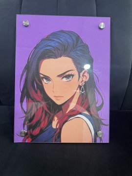 A framed anime-style portrait with a purple background, depicting a young woman with long dark hair streaked with red and striking blue eyes, displayed on a dark surface. The artwork represents the user's PFP (profile picture), which they received as an early birthday gift.