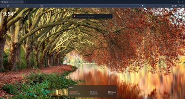 A new tab page in a web browser displaying a scenic autumn forest path with a canal, green and orange trees, and bookmarks at the bottom.