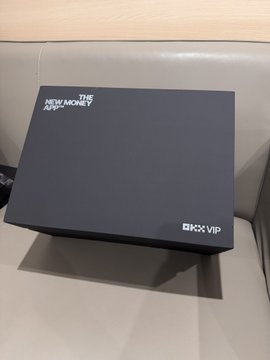 A dark navy 'THE NEW MONKEY' VIP box sitting on a beige surface.