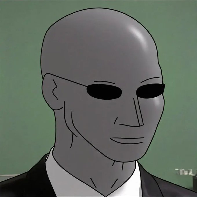 The image features a mannequin head wearing glasses with black sunglasses, giving him an eerie or mysterious appearance. The background of the image is green, which contrasts with the gray hair of the mannequin's head. The caption below the image reads "Wake up to reality, wake up Stop living in the matrix and grab yourself some $NPC". This suggests that the post might be promoting a product or service related to the character from the movie "Stop Living in the Matrix", which is known for its unique and surreal visual style.