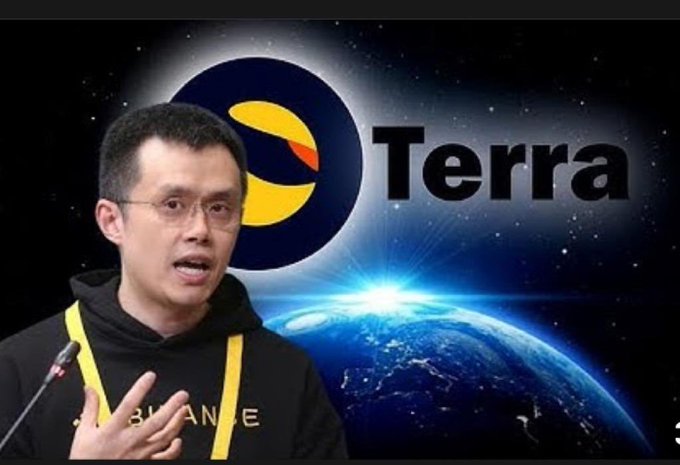 A man wearing a black "BINANCE" hoodie and glasses speaks in front of a backdrop featuring Earth from space and the "Terra" cryptocurrency logo, an image that pairs with a post suggesting Binance CEO CZ will help drive $LUNC's comeback in crypto history.