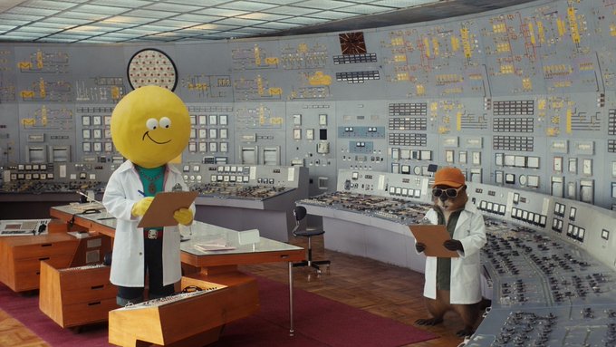 Two mascot characters—one a yellow smiling sphere in a lab coat and the other a squirrel wearing a hard hat and goggles—stand amid an elaborate vintage control room filled with panels of switches, dials, and indicator lights, each holding clipboards as if conducting a scientific experiment. The image humorously ties to the post's "LaboratoRay" theme, depicting Ray and Squirrel as researchers who have launched a Bounty initiative allowing collectors to sweep Del Mundo NFTs priced between 0.035 and 0.0413 ETH for a chance to win an additional Del.