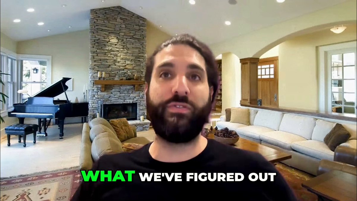 The image shows a man with a beard wearing a black shirt, sitting in front of a piano and a fireplace in a living room setting. The background includes a couch and chairs arranged around the room. The caption reads "What We've Figured Out", which is related to the content of the post by the author.