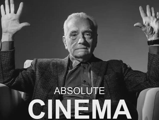 Black and white photo of an older man in a blazer holding his hands up with palms facing forward, with the text 'ABSOLUTE CINEMA' overlaid at the bottom.