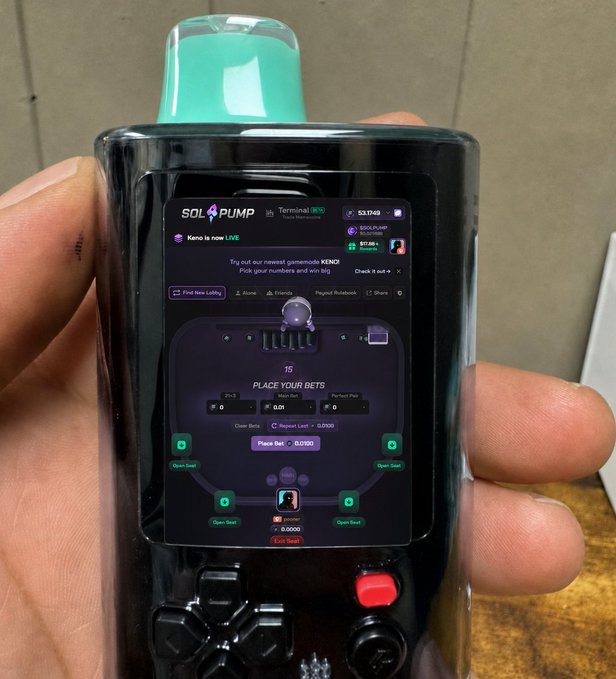 A hand holds a handheld SolPUMP 'Terminal' crypto gambling device with a screen displaying a coin flip betting interface for the new memecoin 'Keno'.