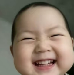 A cheerful baby with a wide, beaming smile showing tiny teeth, eyes squinted in pure joy. The image's carefree, oblivious happiness contrasts sharply with the post's desperate request for crypto donations (BNB/USDT) and complaint about not making money.