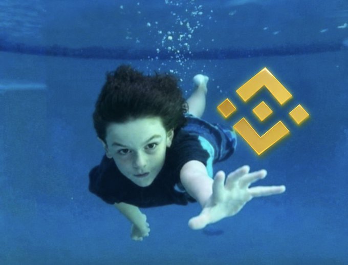 A young boy swimming underwater toward the camera with a hand outstretched, alongside a yellow Binance logo overlay.