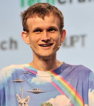 Vitalik Buterin, co-founder of Ethereum, is shown on stage with a headset microphone, wearing a colorful t-shirt featuring UFOs and a llama against a sky background. The partial text "LPT" visible in the background aligns with the post about his statement warning that SI (likely artificial superintelligence) could weaken crypto security.