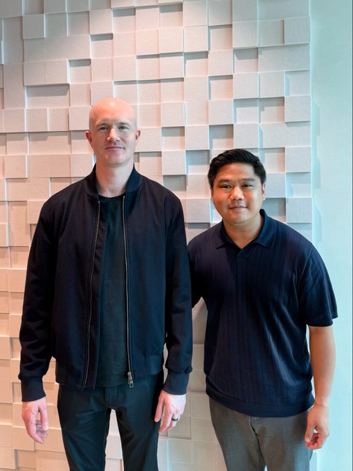 Two men pose together in front of a textured geometric wall at what appears to be a Coinbase-hosted roundtable discussion. The accompanying post references a meeting with Brian Armstrong of Coinbase to discuss local-currency stablecoins like $IDRX and their role in the tokenized economy.