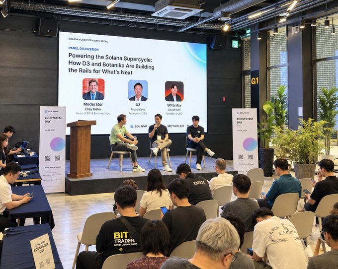 A panel discussion at 'Solana Ecosystem Day | Seoul' titled 'Powering the Solana Supercycle: How D3 and Botanika Are Building the Rails for What's Next,' featuring moderator Clay Heim (Head of BD at Phantom), D3 (Michael Ho, Founder & COO), and Botanika (Spunk Lin, Founder & CEO), with an audience watching.