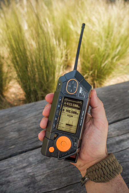 The image features a person holding an electronic device, possibly a walkie-talkie or a similar gadget, with their hand visible. The device has a black and orange color scheme, making it stand out against the background. The text "You already know we're putting @ratspeakorg on it." is written in the caption of the image, indicating that the person holding the device might be associated with ratspeakorg or have an interest in rat-related activities.

The main focus of the image is the person's hand and the electronic device they are holding. The background consists of a wooden surface, which adds to the overall aesthetic of the scene.
