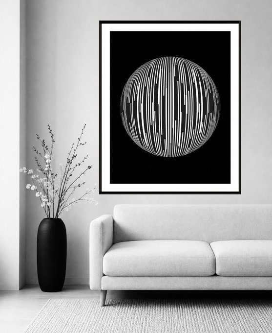 Modern interior scene with a white sofa and black vase holding white blossoms, decorated with a framed black-and-white artwork depicting a sphere composed of vertical white lines.