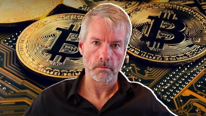A composite image showing a serious-looking man with gray hair and beard (resembling Michael Saylor) superimposed over a background of large golden Bitcoin coins resting on a green circuit board.