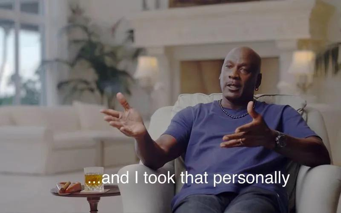 A man in a blue t-shirt sits in a cream-colored armchair gesturing with both hands as he speaks, with a glass of amber liquid on a side table beside him. The caption reads "and I took that personally," reinforcing the post's theme about frustration with people abandoning self-custody in favor of exchanges.