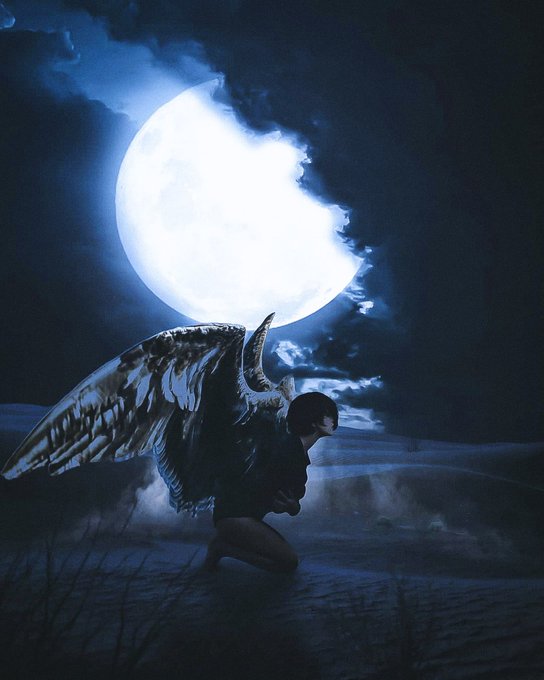 A dark, moody digital artwork depicting a winged figure with horns silhouetted against a large glowing moon and clouds.