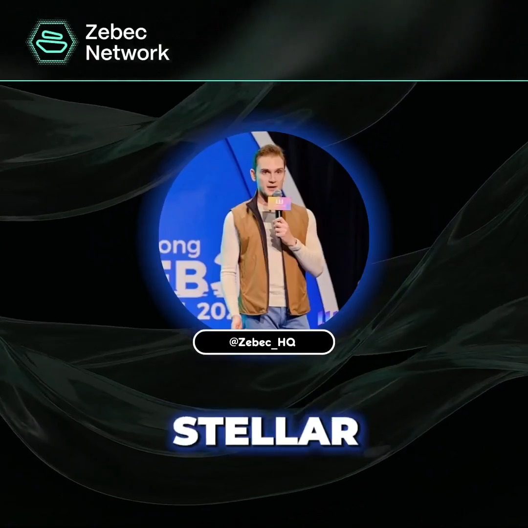 The image features a man standing behind a microphone, giving a speech or presentation. The background of the image is black with blue and white swirls, creating an interesting visual effect. The caption below the image reads "@simonb_ldn discusses Zebec’s multichain strategy and upcoming rollout of the enterprise payroll product on Stellar, built for larger businesses, global payouts and real-time payments." This suggests that the man speaking is likely discussing the new Zebec Enterprise Network product or its features.