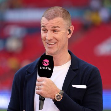 A man in a navy blazer over a white t-shirt speaks into a "TNT SPORTS" microphone while wearing an earpiece, smiling slightly during what appears to be a sports broadcast. The celebratory, taunting caption about "liquidating" an opponent suggests this is a pundit or commentator delivering a victorious post-match analysis, his relaxed, pleased demeanor matching the post's triumphant tone.