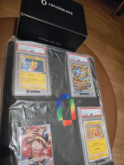 Three graded Pokémon cards—including a Pikachu and a Gyarados—rest alongside an ungraded Luffy card and a "rengiss.xyz" box ("Verified to Be Yours"), relating to the post by documenting the card-pulling trip to Hong Kong's Tsim Sha Tsui center, where "Hear" selected a graded PSA card (likely the 002 in Figure 2) that earned a top prize.
