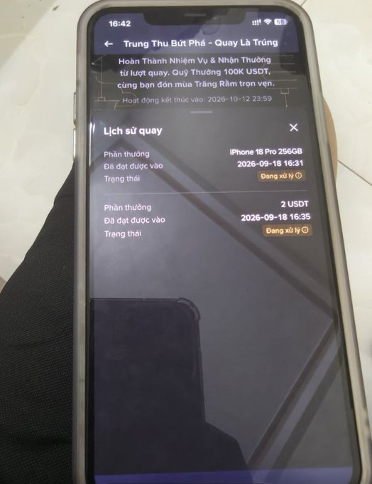 A smartphone screen showing a Vietnamese-language rewards app interface titled 'Trung Thu Bốc Phá - Quay Là Trúng', displaying a history of spinning for prizes including an iPhone 18 Pro 256GB and 2 USDT.
