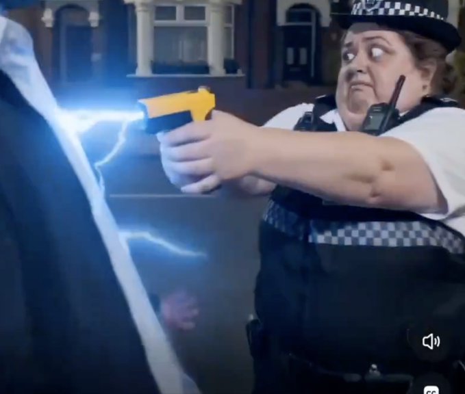 A female police officer in uniform, with a wide-eyed expression, fires a yellow taser that emits blue electricity at an off-camera subject.