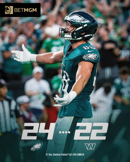 The image is a BetMGM promotional graphic featuring a Philadelphia Eagles player (number 88) in a green jersey and helmet, with arms outstretched in celebration, alongside the final score "24...22" showing the Eagles' victory over Washington. The image illustrates the Eagles' narrow win referenced in the post, which humorously celebrates burning 0.5% of a "$LAPTOP" investment in tribute to the team's victory.