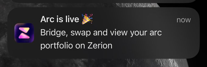 A dark-themed mobile push notification from Arc announcing 'Arc is live' with the message 'Bridge, swap and view your arc portfolio on Zerion'.