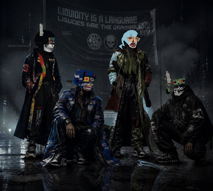 The image features four people posing for a photo, each wearing masks that resemble robots or cyborgs. They are standing next to a banner with the text "Liquity is a language" written on it. The background of the image appears to be a dark room, and there's smoke coming from the ceiling in the background.