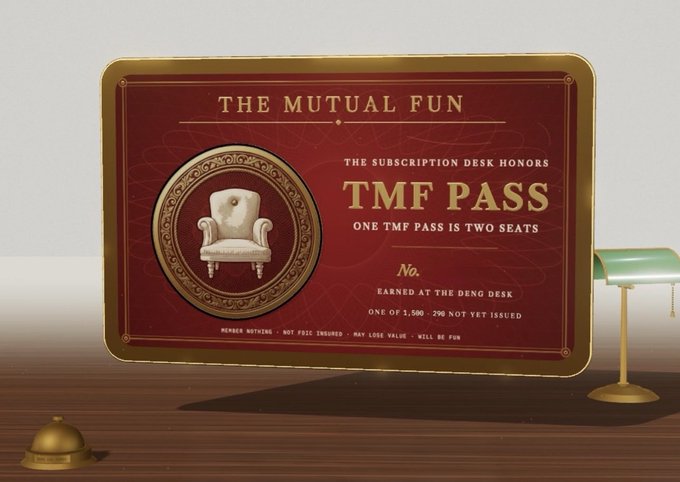 A red and gold 'TMF PASS' card for 'THE MUTUAL FUN' displayed on a wooden desk, noting it represents two seats earned at the Deng Desk, numbered 1,500-290.