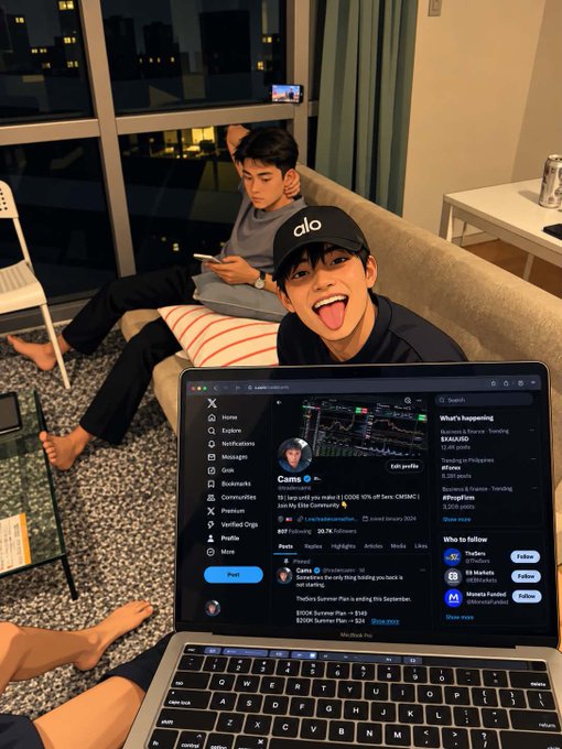 Two young men are relaxing on a sofa in a living room, with one in the foreground sticking his tongue out and wearing a black 'alo' cap, while an open laptop in the foreground displays an X (formerly Twitter) profile page.