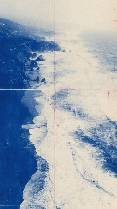 An aerial, vintage-style photograph captures a rugged coastline with white waves crashing against dark cliffs and sandy beaches, marked by faint red lines.