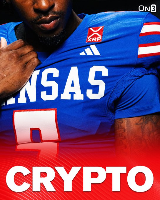 A Kansas football player wears a blue jersey featuring an XRP crypto patch and Adidas branding, with the "ON3" logo in the corner and "CRYPTO" text overlaid in bold red and white, illustrating the new Ripple/XRP sponsorship deal across Kansas athletic programs.