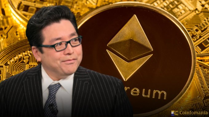 A man wearing glasses and a pinstripe suit stands in front of a large golden Ethereum logo, with 'Ethereum' visible in the text, in an image branded 'Coinfomania'.