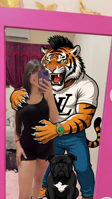 A woman takes a mirror selfie next to a cartoon tiger mascot wearing a "LV" shirt and a green-faced watch, with a black dog at their feet, all framed by a pink border. The image humorously illustrates the post's enthusiasm for the Pulse memecoin "Ptiger," depicting the fierce yet stylish tiger character she loves.