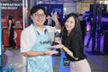 Two people pose together at what appears to be an arcade or entertainment venue, with a "#WhatsTheMove" sign visible in the background, suggesting the post teases their return to a popular gaming or entertainment activity.