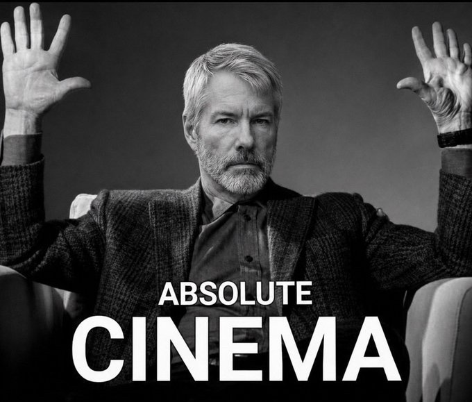 A black and white photo of Harrison Ford in a suit raising both hands in surrender, with bold white text overlay reading 'ABSOLUTE CINEMA'.