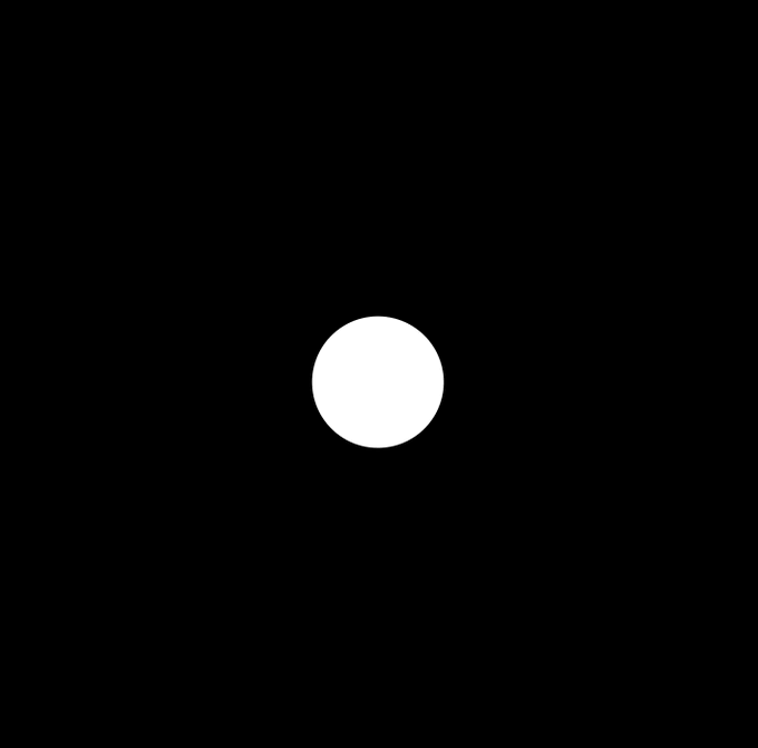 A minimalist image showing a solid white circle centered on a solid black background.