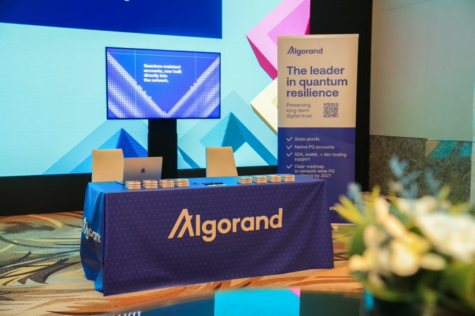 An Algorand booth display with the tagline 'The leader in quantum resilience' and features including stake proofs, native PQ accounts, SDK support, and over a million TPS roadmap for 2027.