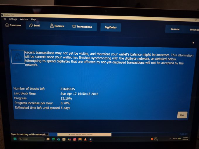 A computer screen displays the DigiByte Core wallet interface, showing 2,160,6535 blocks left to sync at 13.16% progress, with the last block timestamped Sun Apr 17 16:50:15 2016.