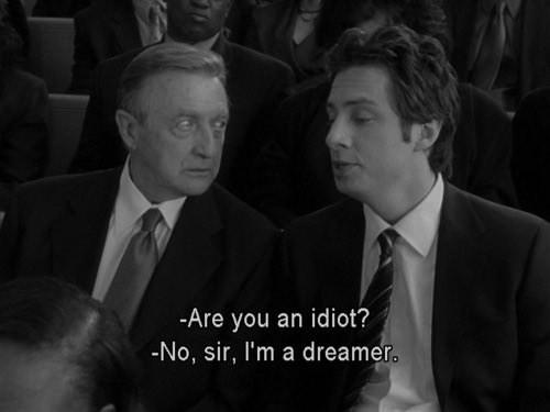 Two men in suits converse in a black-and-white image, with subtitles reading "-Are you an idiot? -No, sir, I'm a dreamer." The meme humorously reframes the recurring crypto "fear, uncertainty, and doubt" (FUD) skeptics as fools dismissing a dreamer, while Bitcoin continues climbing despite all the negative noise.