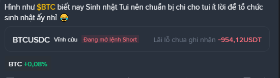 A Vietnamese message reading 'Hình như $BTC biết nay Sinh nhật Tui nên chuẩn bị chi cho tui ít lời để tổ chức sinh nhật ấy nhì 😂' with trading info for BTCUSDC showing 'Đang mở lệnh Short' (Opening Short order) with an unrealized P&L of -954.12 USDT and BTC up +0.08%.