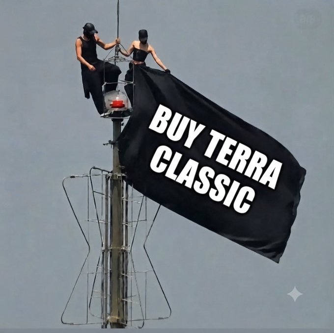 Two people on a tower hoisting a black flag that reads 'BUY TERRA CLASSIC' in white lettering.
