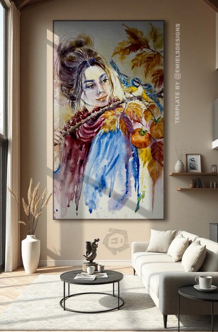 A large framed watercolor painting of a woman with a bird and autumn leaves hangs on a beige wall in a modern living room, marked with the text "TEMPLATE BY @EMIELSDESIGNS".