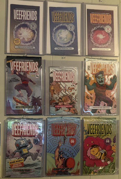 A collection of nine "VEEFRIENDS" collectible comic packs are displayed on a wall, with issue numbers including 01, 02, 03, 04, 06, 07, 08, 09, and 92 visible on their covers.