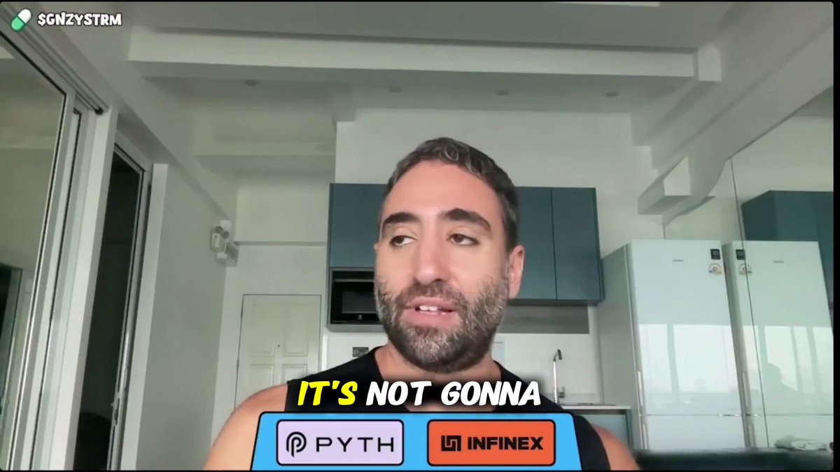 The image shows a man wearing a tank top with a "It's not gonna happen" sign on his chest, which is part of an online advertisement or social media post promoting a product called Infinex. The man appears to be talking about the product in a casual and informal manner, suggesting that he might be a fan or a customer who has used it before.

The image also includes a refrigerator visible in the background, indicating that this is likely taking place in someone's home setting.